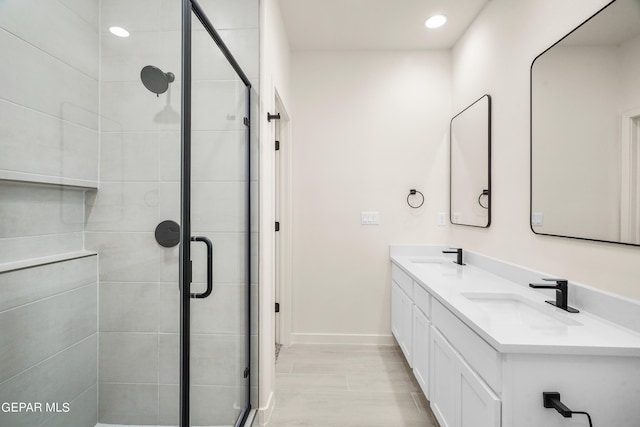 13870 Paseo Central Ave, Horizon City, TX 79928 - full bathroom featuring double vanity, a stall shower, recessed lighting, and baseboards