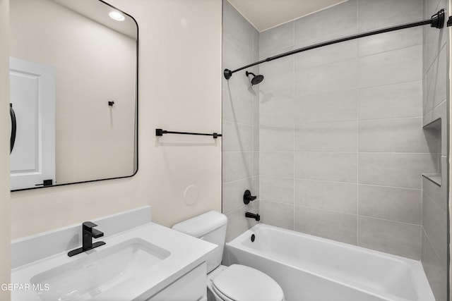 full bathroom featuring vanity, toilet, and tiled shower / bath combo