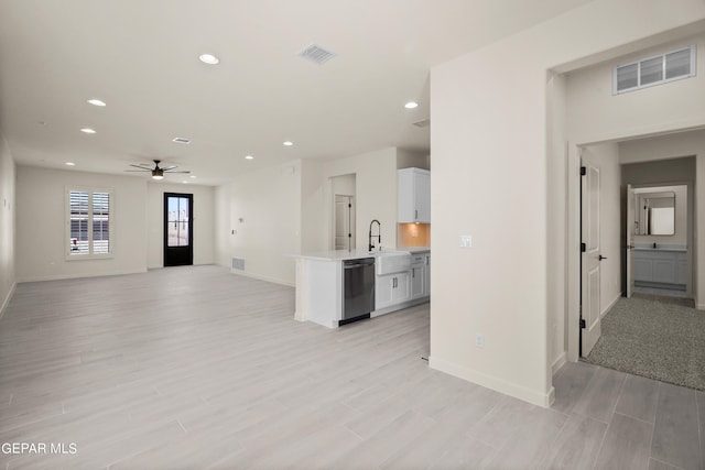 living room with sink, light hardwood / wood-style floors, and ceiling fan