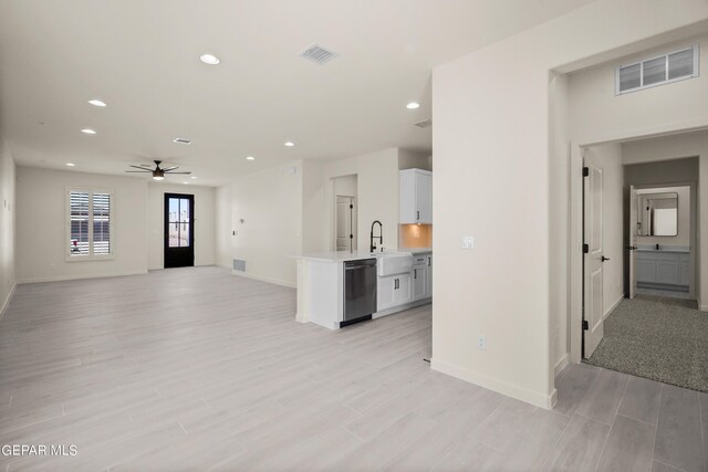 13870 Paseo Central Ave, Horizon City, TX 79928 - kitchen featuring dishwasher, light countertops, ceiling fan, open floor plan, and white cabinetry