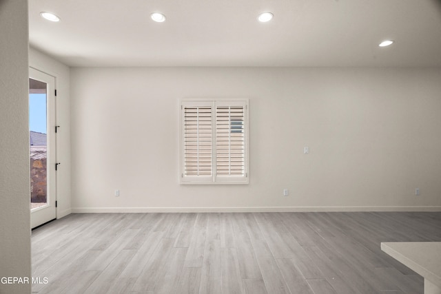 spare room with light hardwood / wood-style flooring