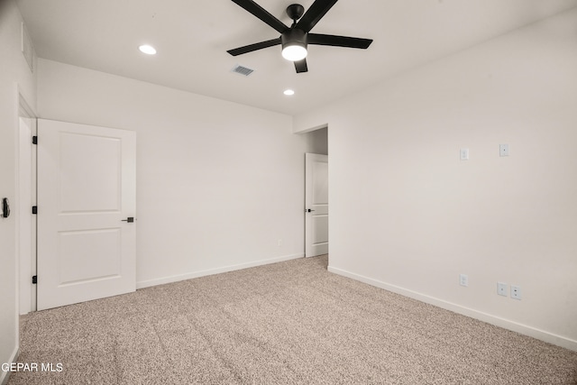 carpeted spare room featuring ceiling fan