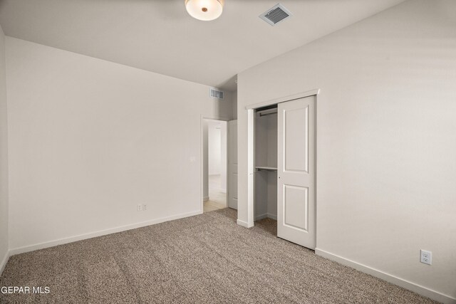 unfurnished bedroom featuring a closet and carpet floors