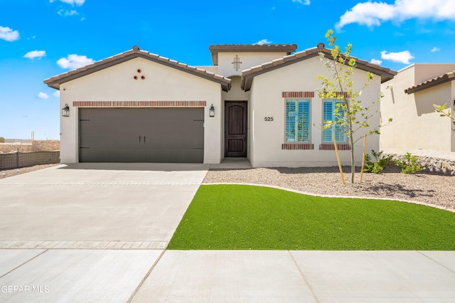 mediterranean / spanish-style house featuring a front yard and a garage