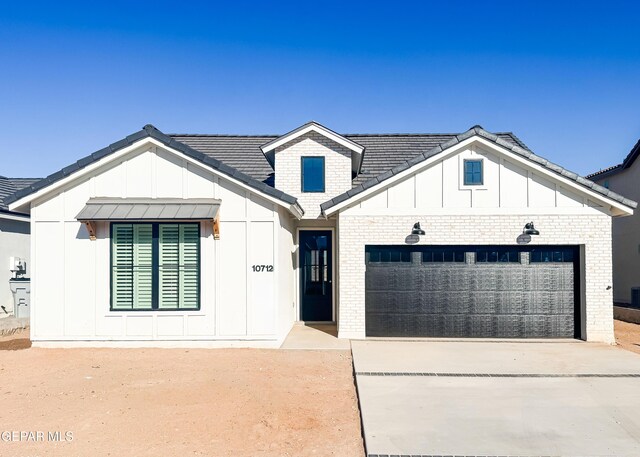 14960 Hill Ridge Ct, El Paso, TX 79938 - modern farmhouse with board and batten siding, a garage, concrete driveway, and brick siding