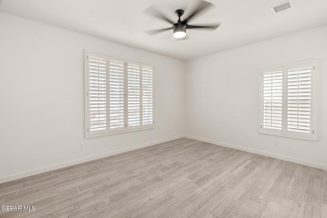 unfurnished room with light hardwood / wood-style flooring, a healthy amount of sunlight, and ceiling fan