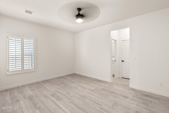 spare room featuring light hardwood / wood-style flooring and ceiling fan