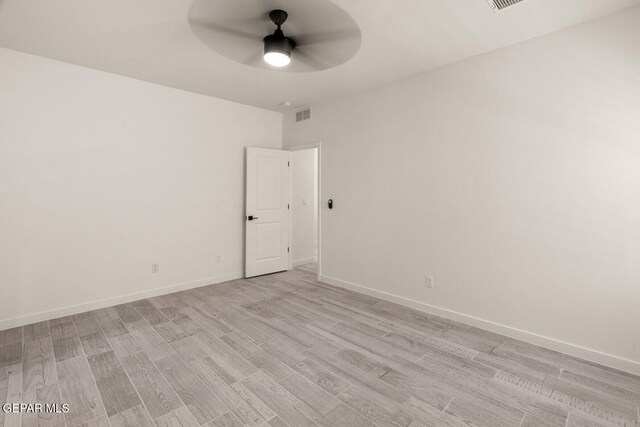 empty room with light hardwood / wood-style floors and ceiling fan