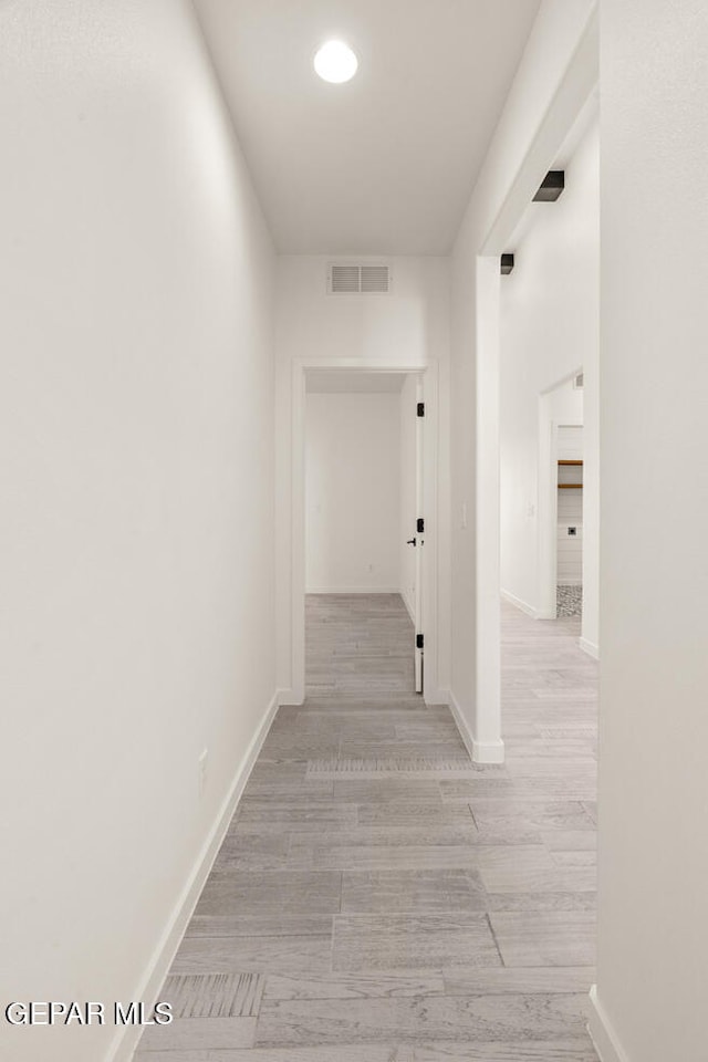 hallway with light hardwood / wood-style flooring