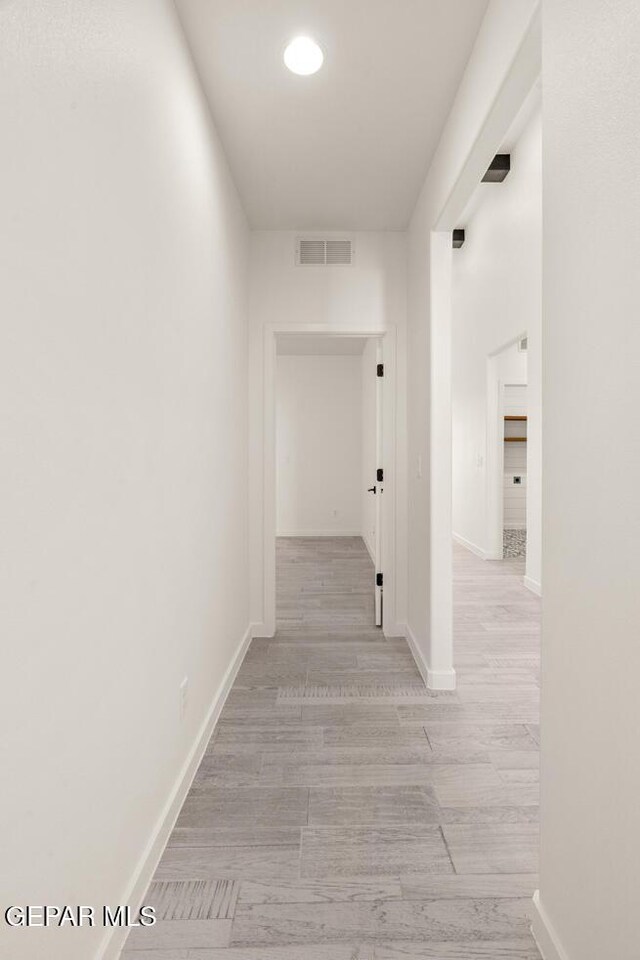 14960 Hill Ridge Ct, El Paso, TX 79938 - corridor featuring light wood-style flooring and baseboards