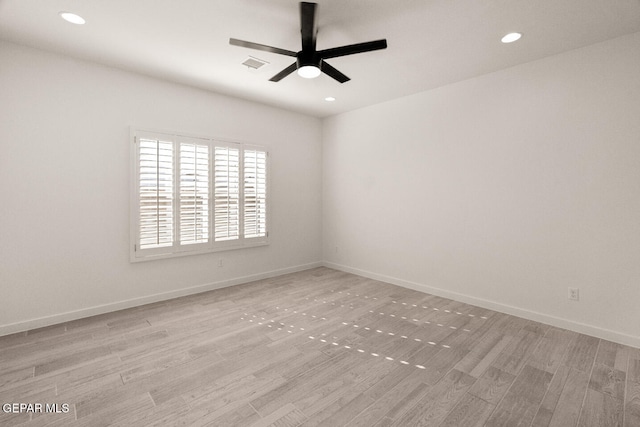 spare room with ceiling fan and light hardwood / wood-style flooring