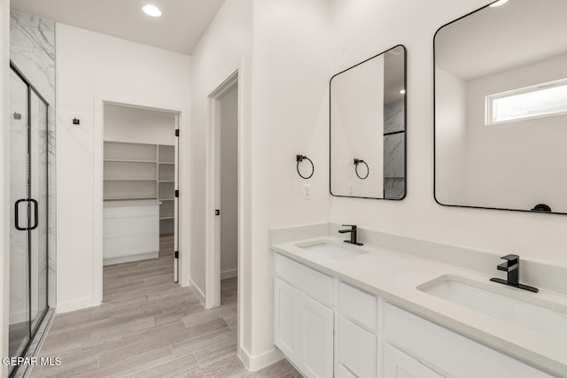 bathroom featuring vanity, a shower with door, and hardwood / wood-style floors