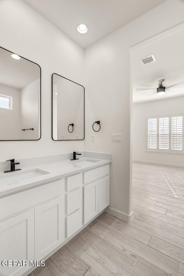 bathroom featuring vanity, hardwood / wood-style floors, and plenty of natural light