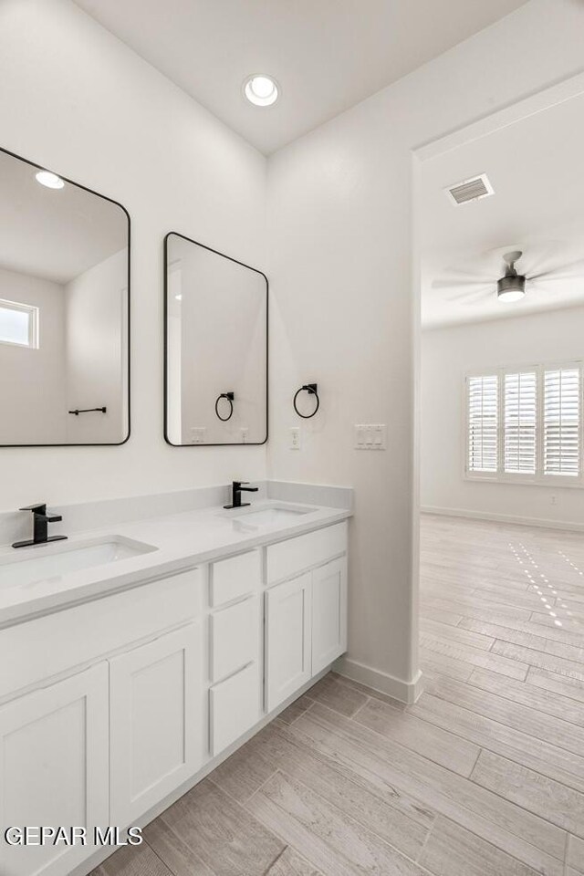 14960 Hill Ridge Ct, El Paso, TX 79938 - bathroom featuring double vanity, healthy amount of natural light, wood finished floors, baseboards, and recessed lighting