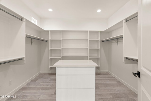 walk in closet featuring light hardwood / wood-style flooring