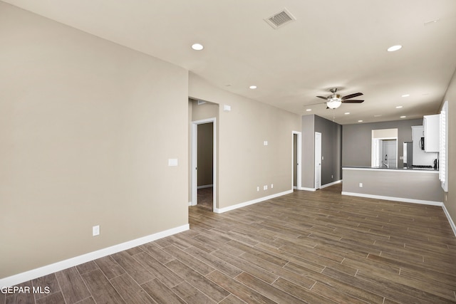 unfurnished living room with ceiling fan and dark hardwood / wood-style flooring