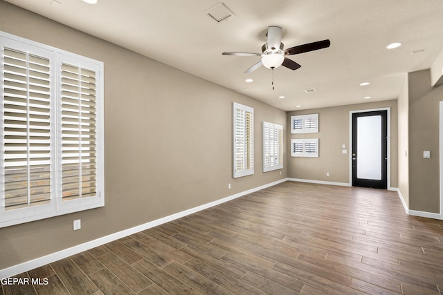 spare room with hardwood / wood-style flooring and ceiling fan