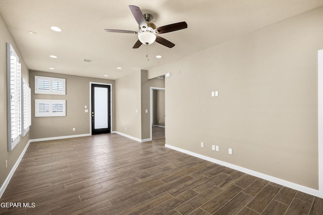 unfurnished room featuring ceiling fan and dark hardwood / wood-style flooring