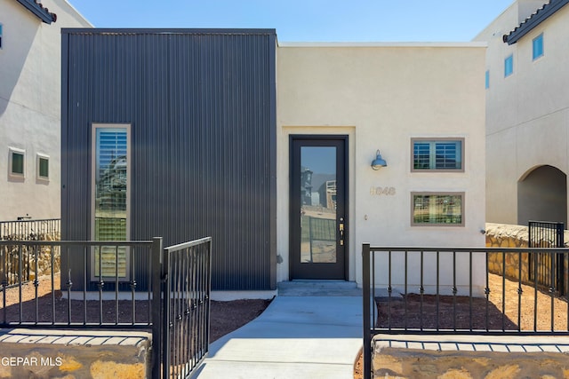 5848 Kobe Bryant St, El Paso, TX 79924 - view of exterior entry with a gate and stucco siding
