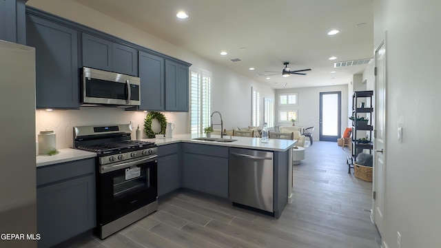5848 Kobe Bryant St, El Paso, TX 79924 - kitchen with stainless steel appliances, a sink, a peninsula, recessed lighting, and ceiling fan