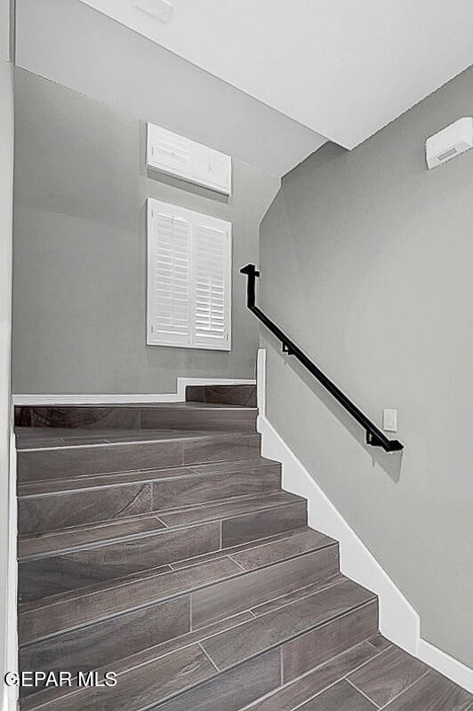 staircase with hardwood / wood-style flooring