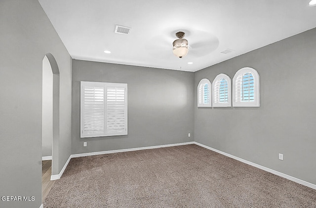 carpeted empty room with ceiling fan