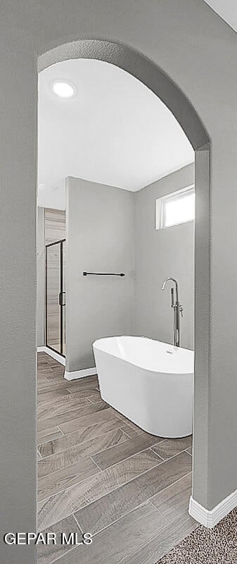 bathroom featuring hardwood / wood-style floors and a tub