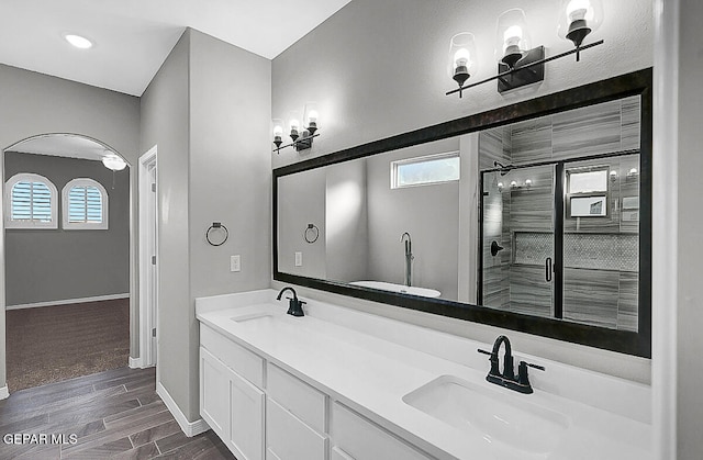 bathroom featuring vanity, hardwood / wood-style flooring, and a shower with shower door