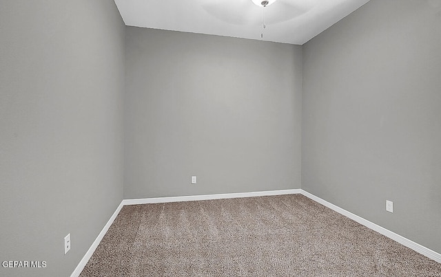 unfurnished room with ceiling fan and carpet flooring