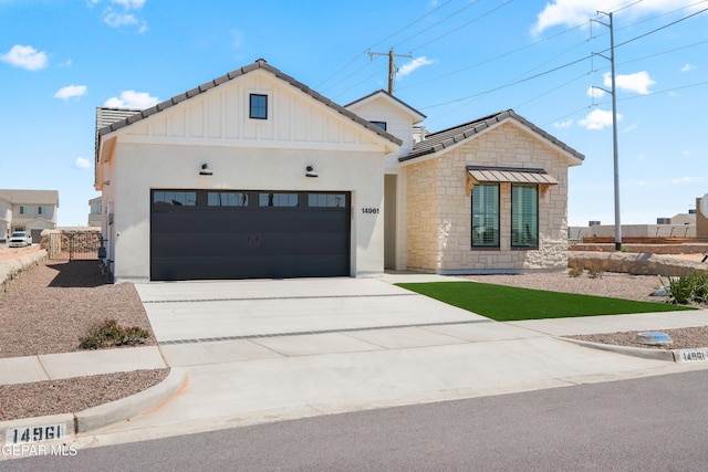 14956 Hill Ridge Ct, El Paso, TX 79938 - view of front of property with an attached garage, driveway, stone siding, and a tiled roof