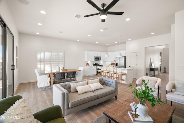 14956 Hill Ridge Ct, El Paso, TX 79938 - living room featuring a ceiling fan, light wood-style floors, recessed lighting, and baseboards