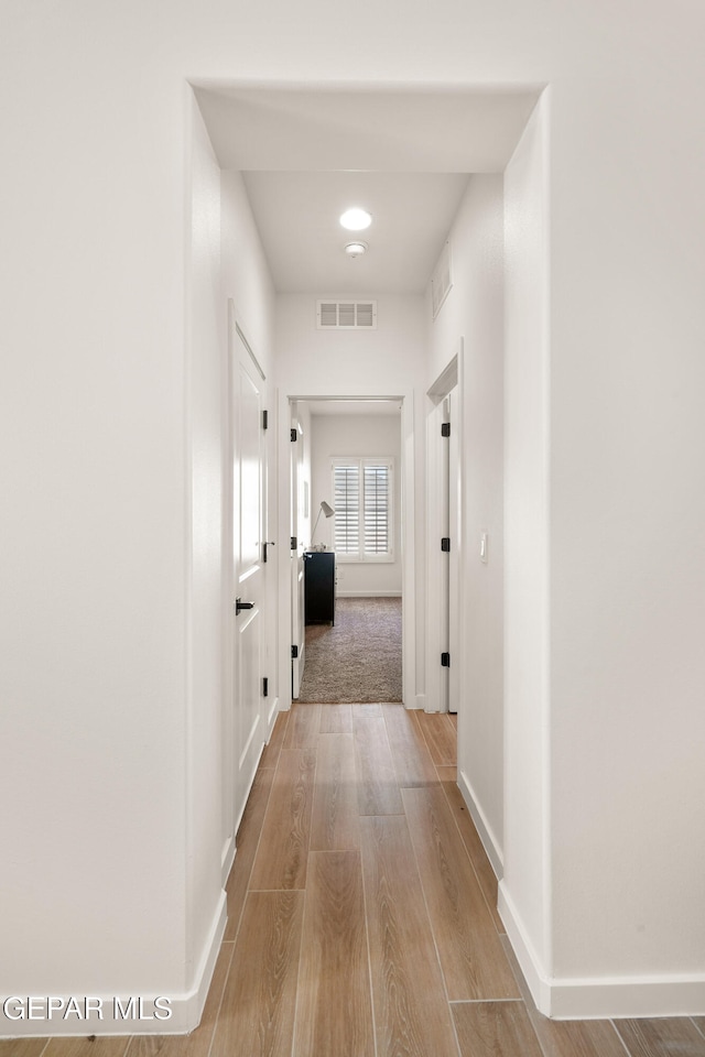 corridor featuring light hardwood / wood-style flooring