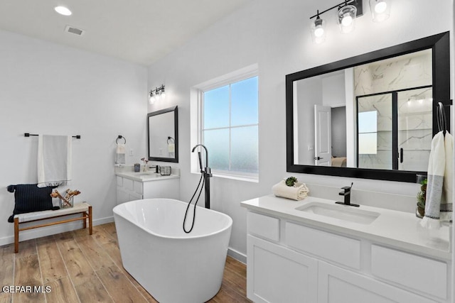 14952 Hill Ridge Ct, El Paso, TX 79938 - full bath featuring a soaking tub, a marble finish shower, wood finished floors, and vanity