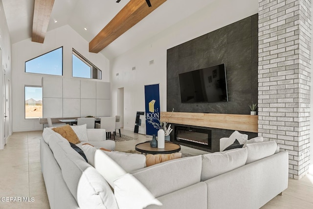 living room with beamed ceiling, light tile patterned floors, and high vaulted ceiling