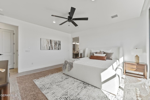 bedroom with ensuite bath, ceiling fan, and light carpet