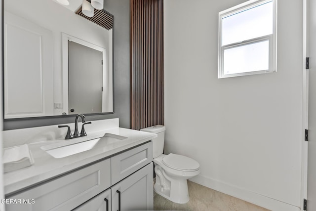 bathroom with tile patterned flooring, vanity, and toilet