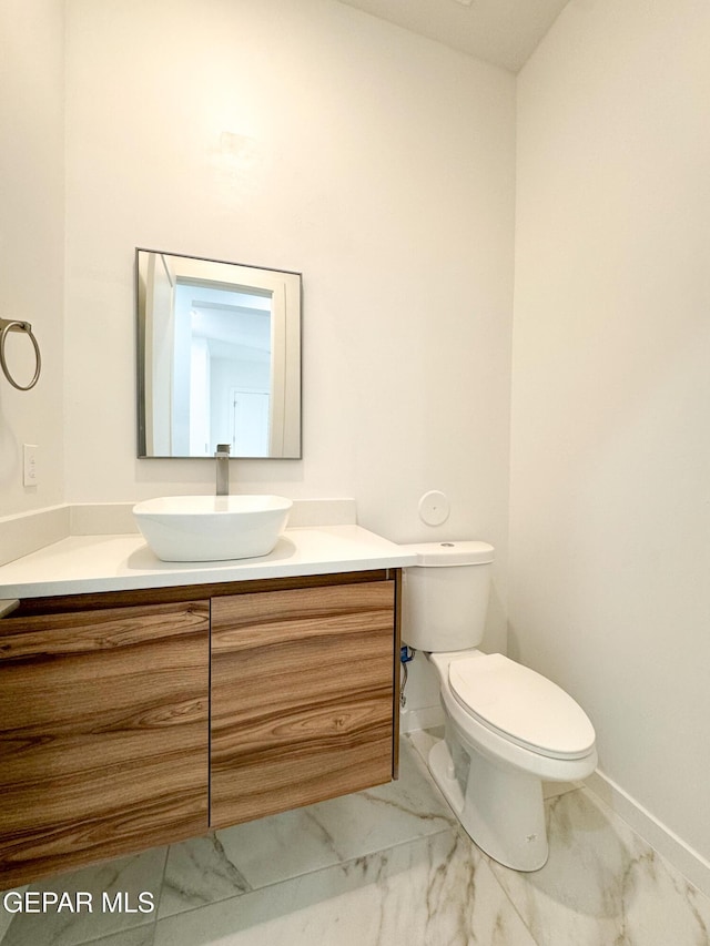 1783 Urijah Pl, El Paso, TX 79928 - half bathroom featuring marble finish floors, vanity, toilet, and baseboards