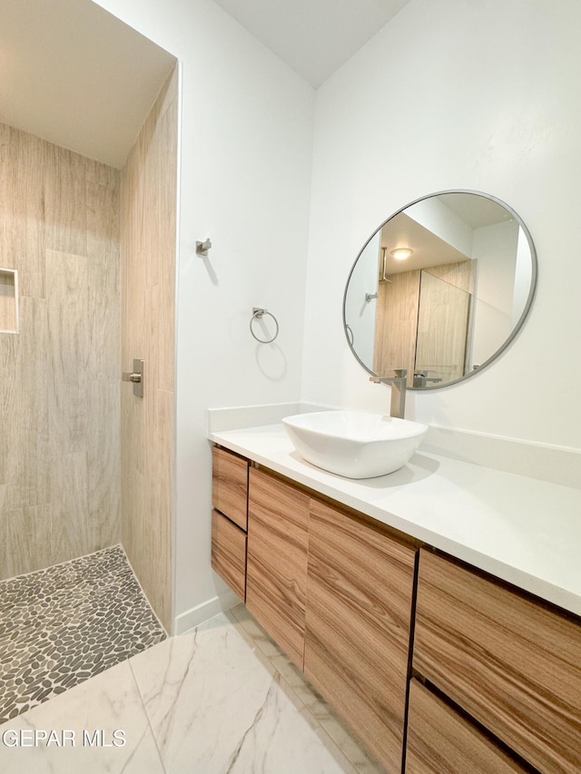 1783 Urijah Pl, El Paso, TX 79928 - bathroom with vanity, tiled shower, and marble look tile flooring