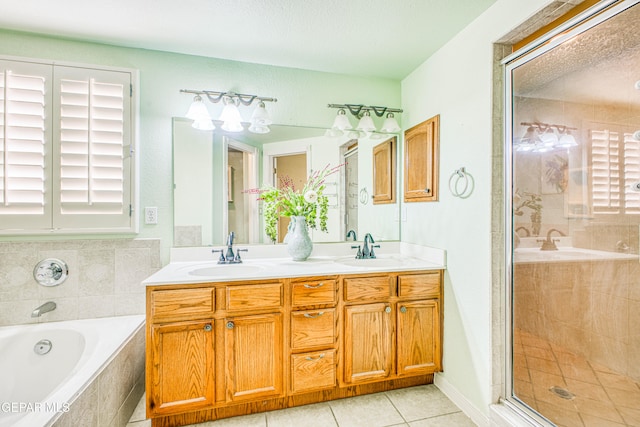 bathroom with vanity, tile patterned flooring, and plus walk in shower