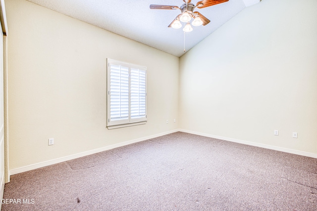 carpeted empty room with ceiling fan and vaulted ceiling