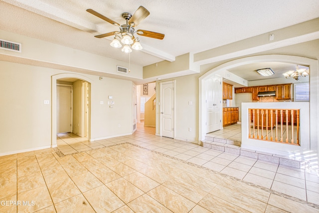 spare room featuring ceiling fan, a textured ceiling, and light tile patterned floors