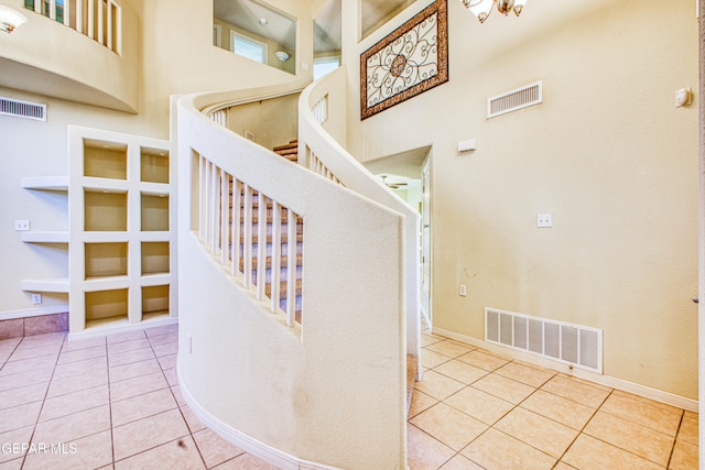 stairway with tile patterned floors