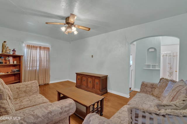 living room with light hardwood / wood-style flooring and ceiling fan