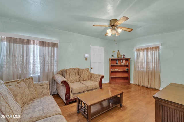 living room with ceiling fan and light wood-type flooring