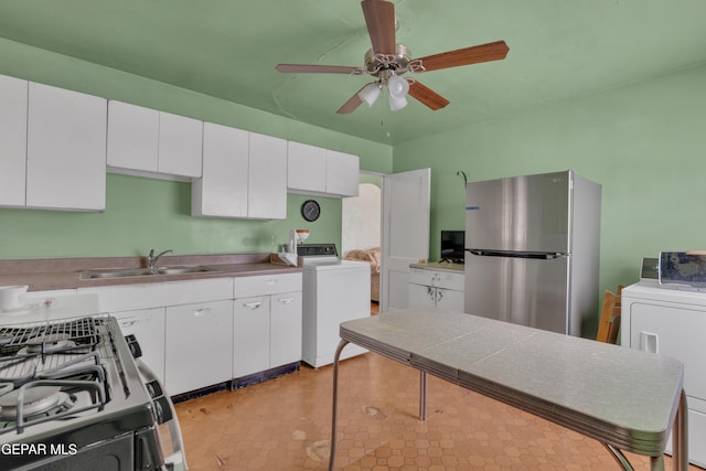 kitchen with washer / clothes dryer, white cabinetry, stainless steel appliances, and sink