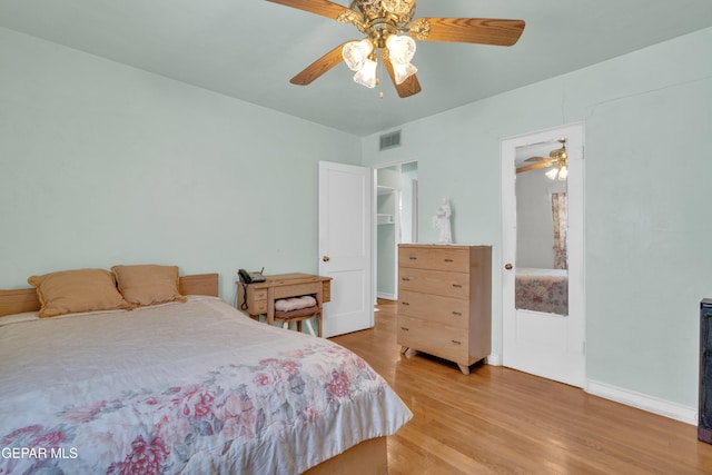 bedroom with light hardwood / wood-style flooring and ceiling fan