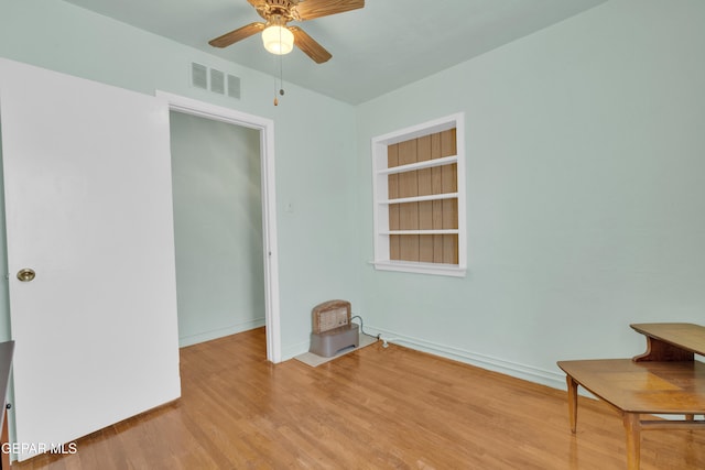 spare room with light wood-type flooring and ceiling fan