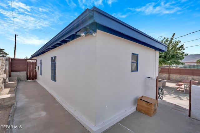 view of side of property featuring a patio