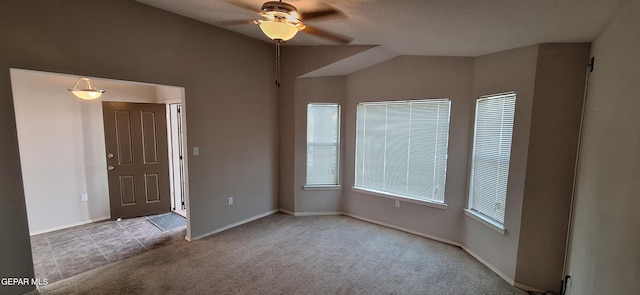 carpeted spare room with lofted ceiling and ceiling fan