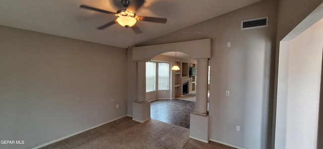 tiled spare room featuring decorative columns, lofted ceiling, and ceiling fan